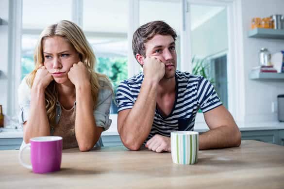 Annoyed couple ignoring each other in the kitchen