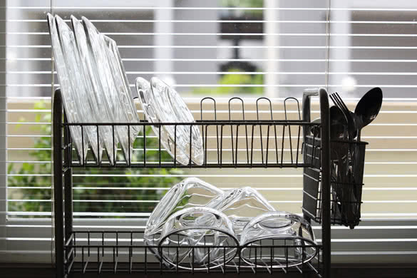 bowls and plates glasses on a dish rack