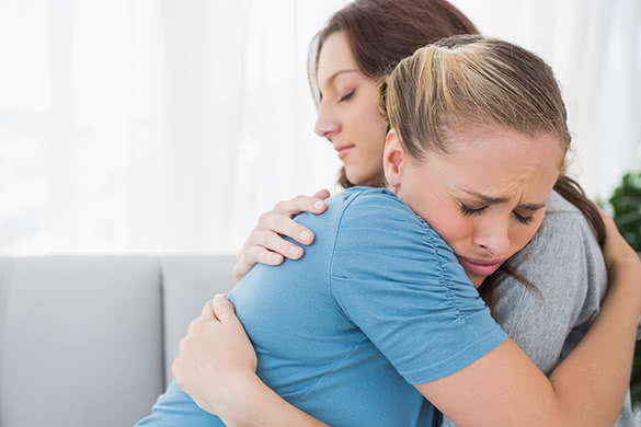 woman hugging her sad friend