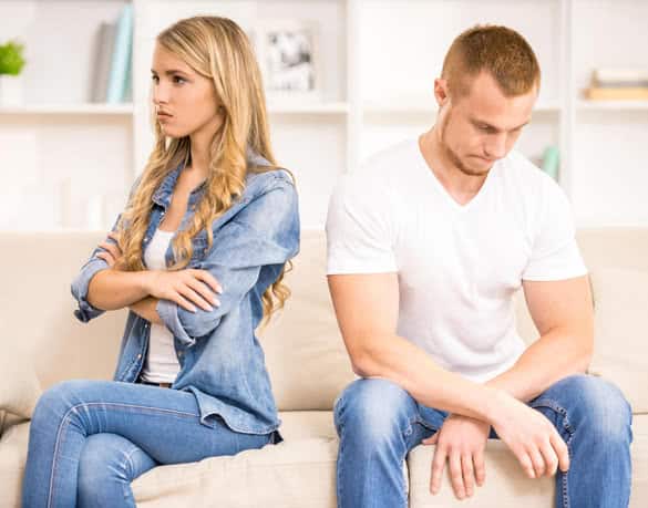 Angry woman sitting back to her husband