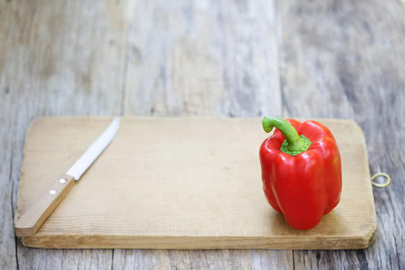Bell pepper and knife on chopping block