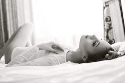 Close-up of sensual woman lying on bed