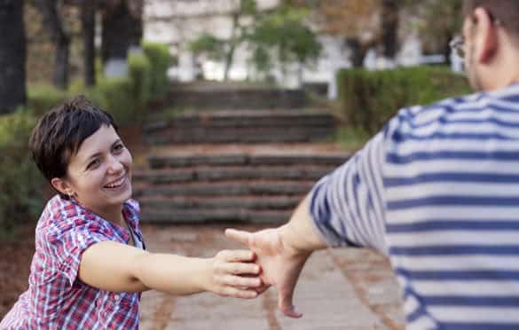 Man and woman hands reaching for each other