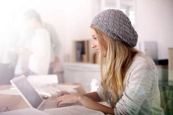 Portrait of student girl working on laptop