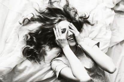 Pretty blonde woman have fine on her bedroom