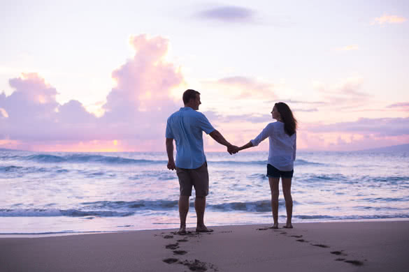 Young Lovers Walking on the Beach at Sunset on Tropical Vacation