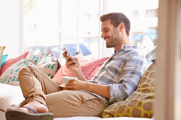 Young man sitting on sofa in a cafe