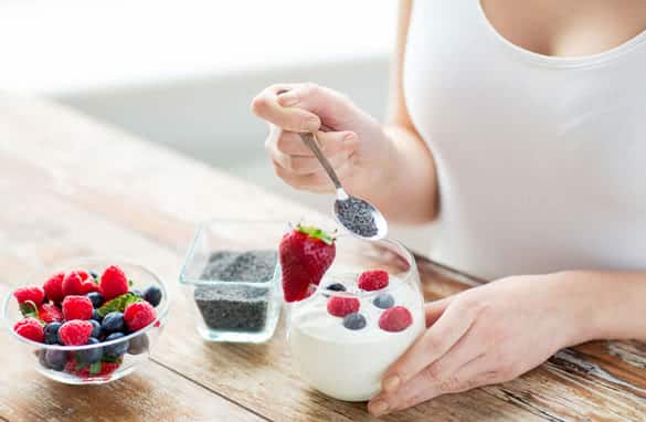 berries and poppy or chia seeds on spoon