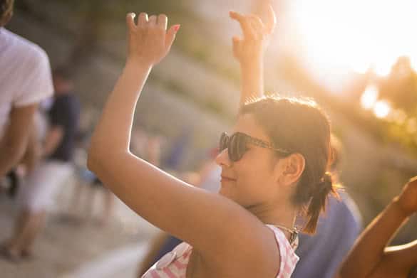 Dancing woman near the swimming pool