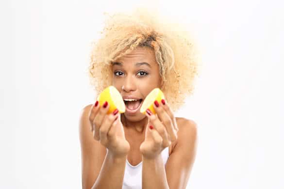 Dark skinned girl with fruits lemon