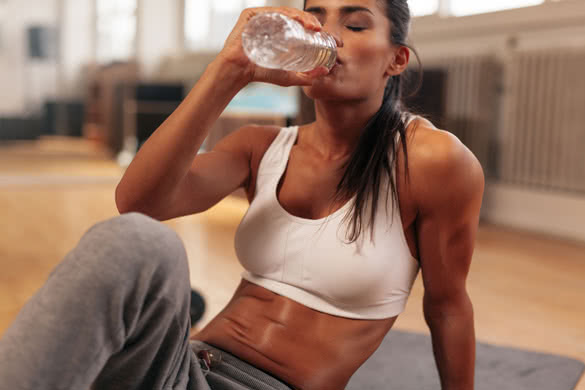 Fitness woman drinking water from bottle