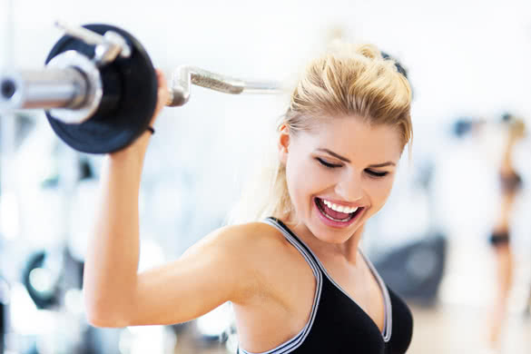 Woman in gym lifting weights 3