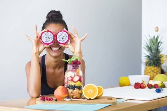 Woman smiling with a tropical fruit salad