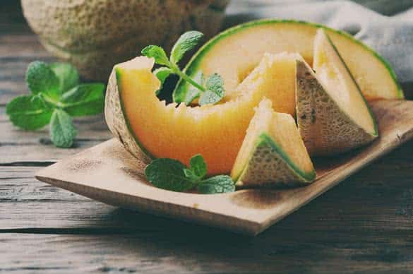 Fresh sweet orange melon on the wooden table