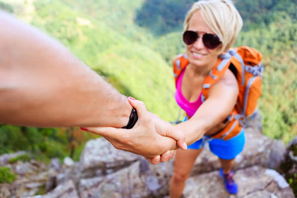 Man and woman teamwork climbing or hiking with motivation and inspiration