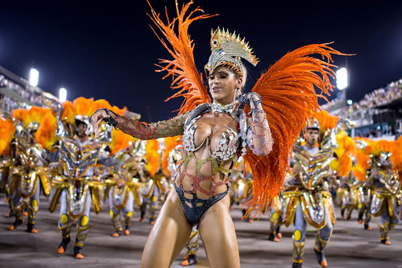 RIO DE JANEIRO, BRAZIL - MARCH 03: Members of Unidos da Tijuca Samba School during their parade at 2014 Brazilian Carnival at Sapucai Sambadrome on March 03, 2014 in Rio de Janeiro, Brazil. Rio's two nights of Carnival parades began on March 2 in a burst of fireworks and to the cheers of thousands of tourists and locals who have previously enjoyed street celebrations (known as "blocos de rua") all around the city. (Photo by Buda Mendes/Getty Images)