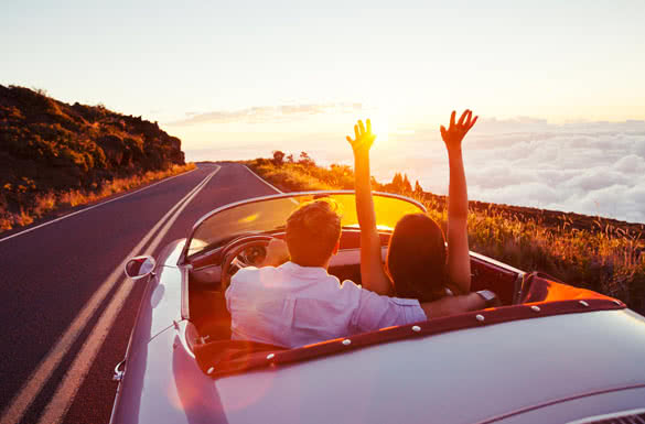 Romantic Young Couple Enjoying Sunset Drive in Classic Vintage Sports Car