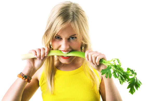 Woman eating a celery very aggressively