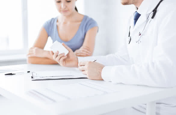 close up of patient and doctor prescribing medication