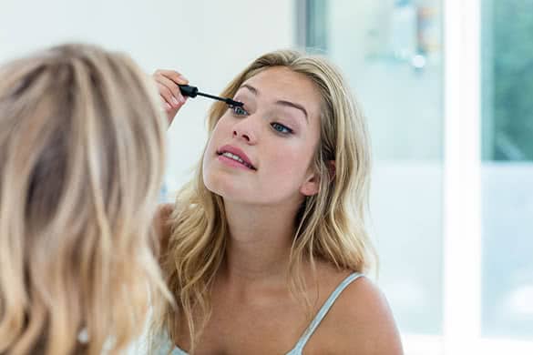 woman applying mascara