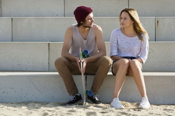 young couple sitting on large concrete steps