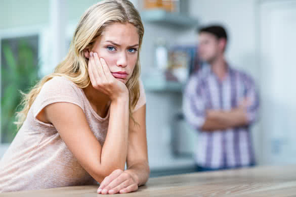 Annoyed couple ignoring each other in the kitchen