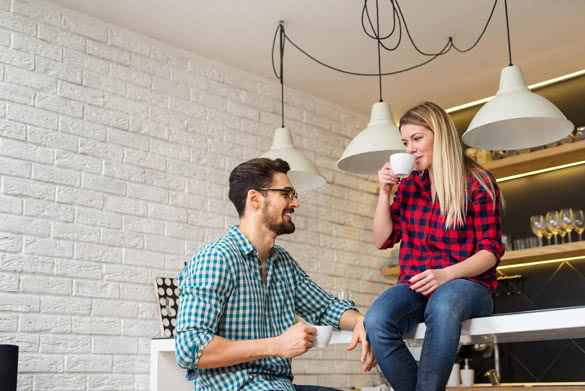 Attractive couple chatting while drinking coffee