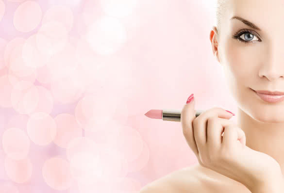 Beautiful young woman with lipstick over abstract pink background