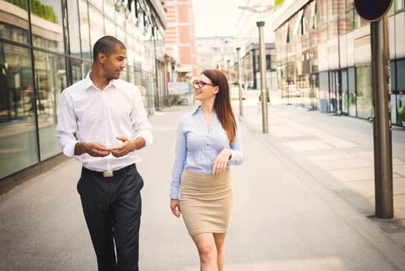 Business couple walking trough passage