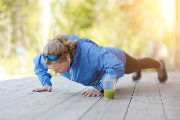 Photo of a young athletic woman exercising outdoor