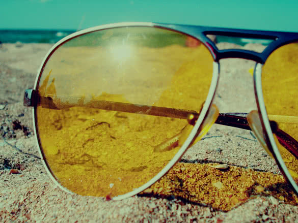 Sunglasses on the sand near the sea in summer