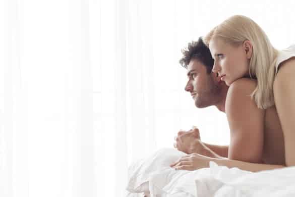 Thoughtful young couple in bed