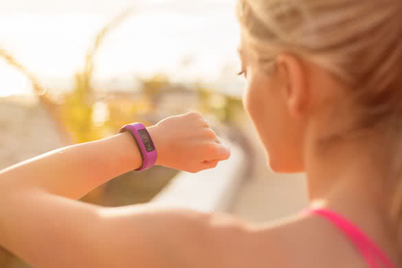 Woman looking at wearable fitness device