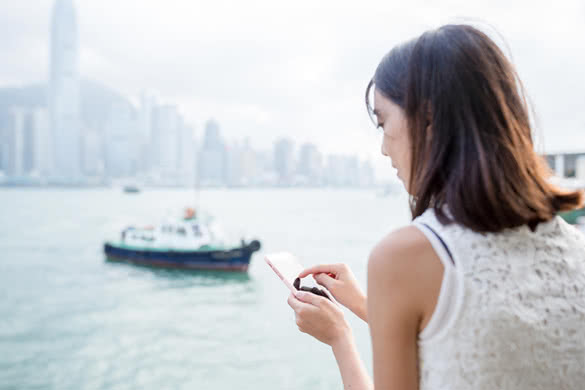 Woman using cellphone at Hong Kong city