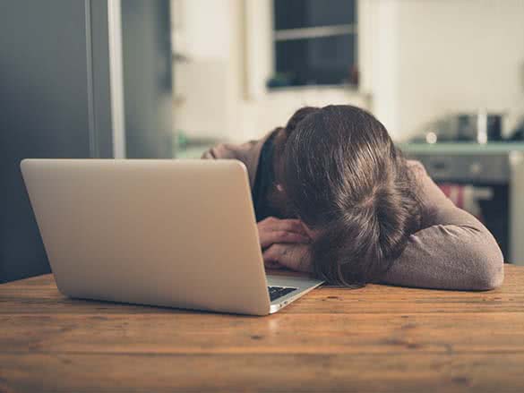 woman lying on a laptop