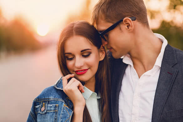 Pretty young girl in jeans jacket and her handsome boyfriend dating