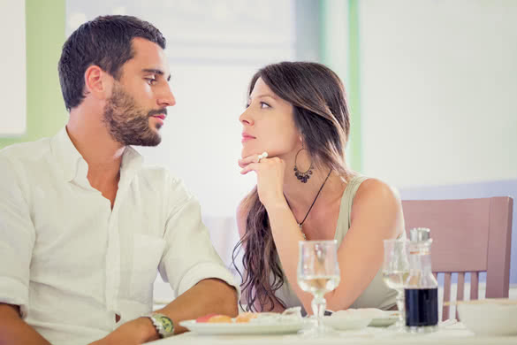 Young romantic brunette couple talking at restaurant