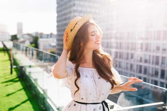 Full-lengh photo of pretty girl with long hair sitting on floor on the terrace