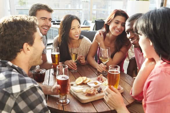 Group Of Friends Enjoying Drink And Snack In Rooftop Bar 2