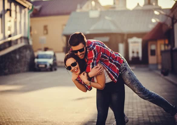 positive and carefree couple having fun in city