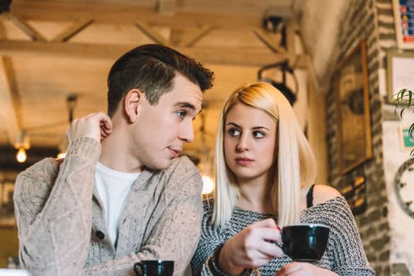 Two young adults in a cafe making some decisions 2