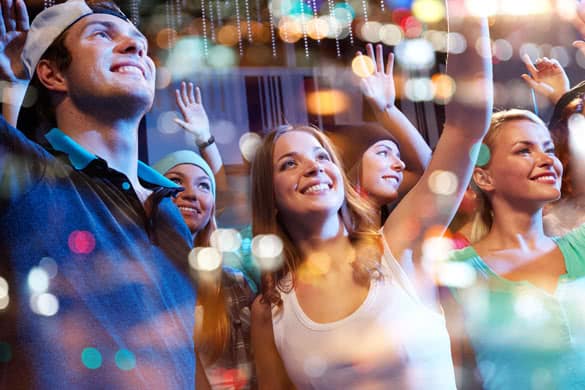 group of happy friends at hip-hop concert in night club