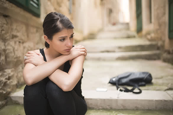 sad woman sitting on stairs