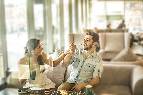 man and woman laughing at a cafe 