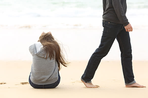 sad woman sitting on a beach