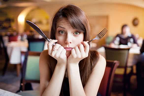 woman holding fork and knife