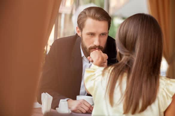 Cheerful young loving couple is dating in cafe