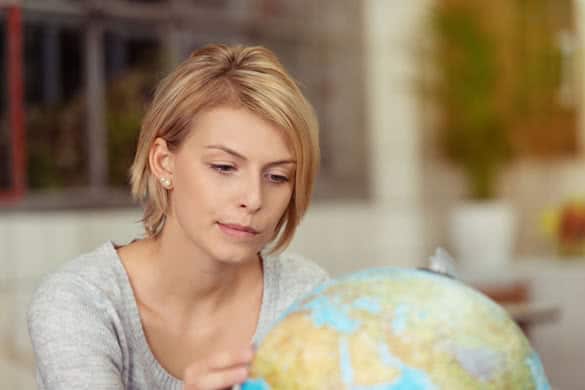 Close up Attractive Young Woman with Short Blond Hair Looking at the Globe Seriously