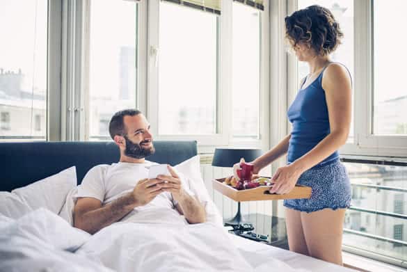 Couple having breakfast in bed