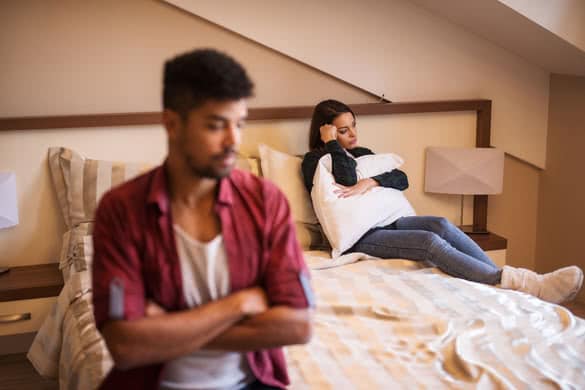 Couple not speaking to each other in bedroom